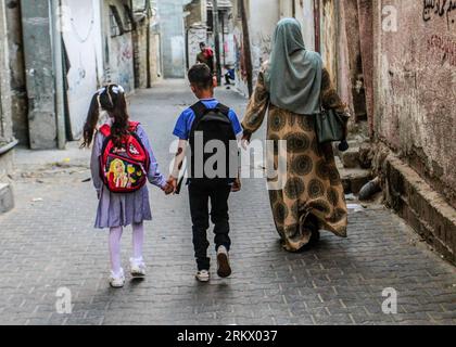 Gaza City, Palestine. 26th Aug, 2023. Palestinian children in school uniforms head to the first day of the new academic year in the Jabalia camp in the northern Gaza Strip. Credit: SOPA Images Limited/Alamy Live News Stock Photo