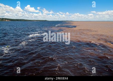 Confluence of the Rio Negro and Solimoes forming the Amazon river ...