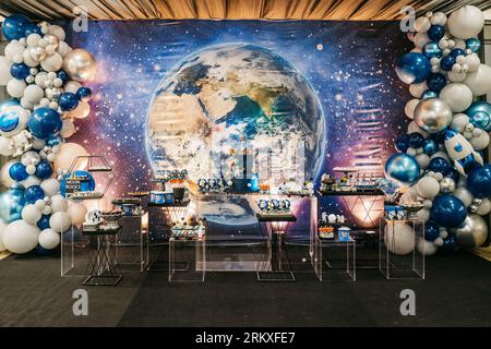 A decorated birthday table in space theme set up for a festive event Stock Photo