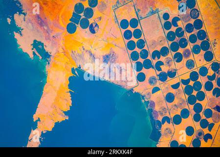 Crop circles or agriculture with a central irrigation system in the area of the Toshka Lakes in Egypt. Digital enhancement of an image by NASA. Stock Photo