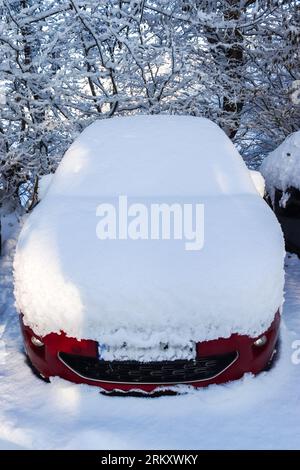 A Car Completely Covered With Thick Snow After A Snowstorm Stock Photo