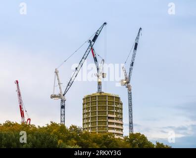 Several Cranes On Constructions Sites At High Buildings All Over Europe. Stock Photo