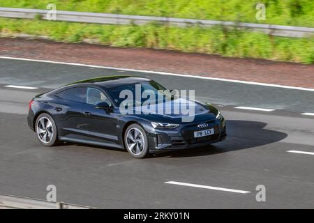 2022 Audi E-Tron Gt Quattro 476 Quattro Electric 93.4Kwh Black Car Saloon Electricity 350 kW travelling at speed on the M6 motorway in Greater Manchester, UK Stock Photo