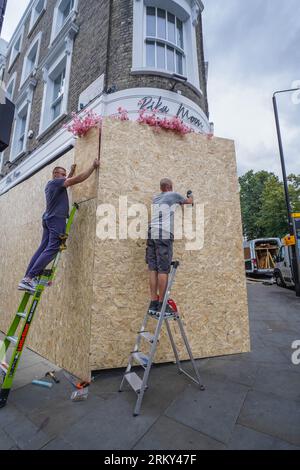 London UK. 26 August 2023 . A shop is boarded up in preparation for the Notting Hill carnival. The Notting Hill Carnival as Europe’s largest street festival, which celebrates Caribbean culture, is expected to attract over 1 million revellers  each day over the bank holiday weekend .Credit amer ghazzal/Alamy Live News Stock Photo
