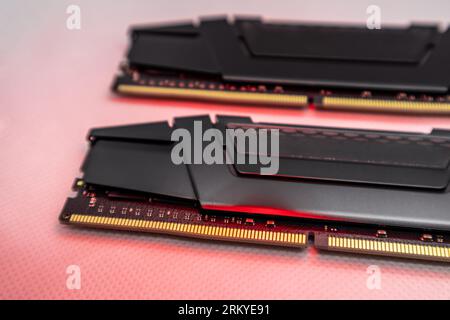 DDR4 DRAM memory modules in red light. Computer RAM chip close-up on white. Desktop PC memory parts for assemble Stock Photo