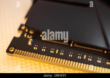 DDR4 DRAM memory module golden electrical contact macro. Computer RAM chip close-up. Desktop PC memory parts Stock Photo