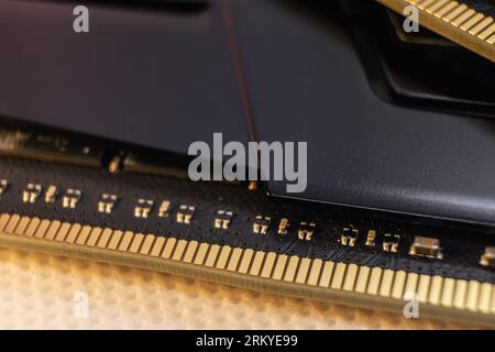 DDR4 DRAM memory module golden electrical contact macro. Computer RAM chip close-up. Desktop PC memory parts for assemble Stock Photo