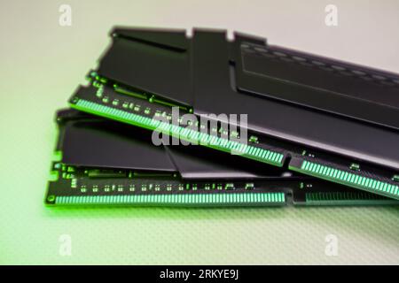 DDR4 DRAM memory modules. Computer RAM chip close-up on white in green light. Desktop PC memory parts for assemble Stock Photo