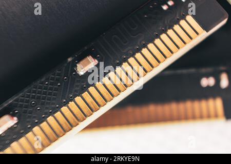 DDR4 DRAM memory module golden electrical contact macro. Computer RAM chipset hardware close-up. Desktop PC memory parts for assemble Stock Photo
