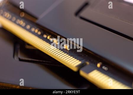 DDR4 DRAM memory module golden electrical contact macro. Computer RAM chip components close-up. Desktop PC memory parts for assemble Stock Photo
