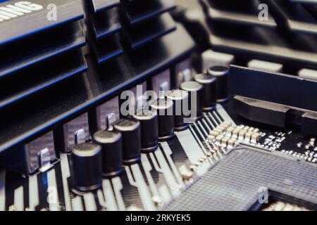 Motherboard with sockets and microchips close-up on a desktop PC. Computer hardware chipset components. Tech electronics background Stock Photo