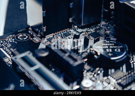 Motherboard sockets and microchips close-up on modern desktop PC. Computer hardware chipset components. Tech industry electronics background Stock Photo