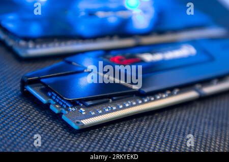 DDR4 DRAM memory modules in blue light. Computer RAM chipset close-up. Desktop PC hardware components Stock Photo