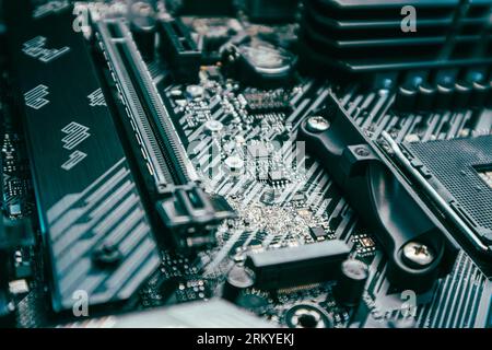 Motherboard with sockets and microchips close-up on modern powerful desktop PC. Computer hardware chipset components. Tech industry electronics backgr Stock Photo