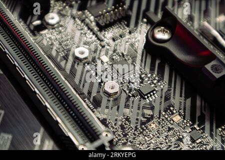 Motherboard sockets and microchips close-up on desktop PC. Computer hardware chipset components. Technology industry electronics background Stock Photo
