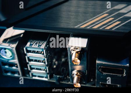 Motherboard USB, keyboard, HDMI, antenna sockets connectors close-up on modern powerful desktop PC. Computer hardware chipset components. Tech electro Stock Photo