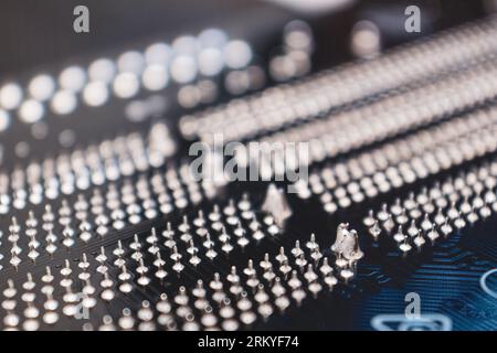 Motherboard backside close-up with pin contacts, desktop PC. Computer technology hardware background Stock Photo