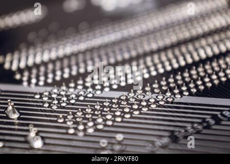 Motherboard backside close-up with pins contacts, desktop PC. Computer technology hardware components background Stock Photo