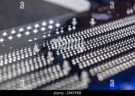 Motherboard backside close-up with pins, desktop PC. Computer technology hardware components background Stock Photo