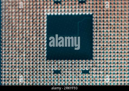 CPU microchip golden pins contacts close-up pattern. Desktop PC computing processor unit details with selective focus view Stock Photo