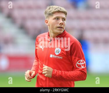 Wigan, UK. 26th Aug, 2023. John Mcatee #45 of Barnsley celebrates his ...