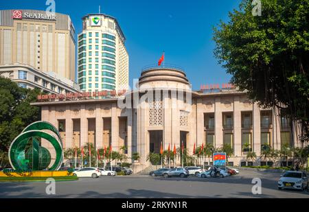 The State Bank of Vietnam seen in the late afternoon with high rise buildings belonging to other banks rising behind in Hanoi, Vietnam.  The building Stock Photo