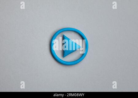 3d simple play button, 3d media play sign on grey background. Plasticine object. Control panel concept. Stock Photo