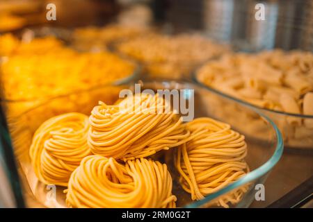 Traditional Italian fresh made colorful organic pasta in shop window. Italian food at a farmer's market in Pisa, Italy.  Stock Photo