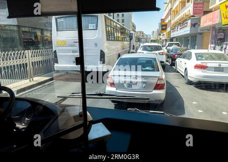Day traffic in Manama Bahrain through the bus window Stock Photo