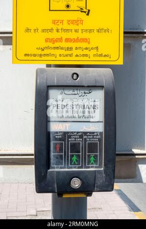 Push button crossing box for pedestrians in Bahrain Bilingual signs Arabic, English, Hindu Stock Photo