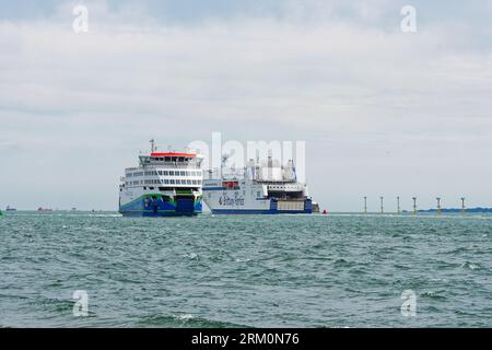 Two car ferries passing in opposite directions outside the entrance to Portsmouth Harbour Hampshire England UK Stock Photo