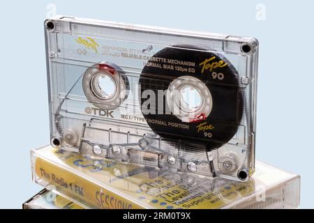 Clear casing of a TDK compact cassette shows the intricate internal layout. Audio compact cassette tapes popular for home recordings, with the C90 in Stock Photo