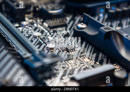 Kyiv, Ukraine - January 05, 2022: Asus Tuf Gaming modern PC motherboard with microchips and sockets. Computer hardware chipset components close-up in Stock Photo