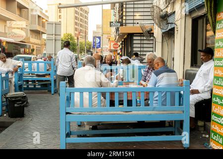 Bahraini men playing cards at the outdoor cafe in Manama Bahrain Stock Photo
