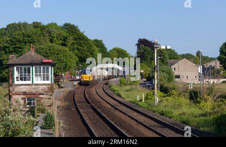 A train passing Arnside railway station signal box, Cumbria, UK Stock ...
