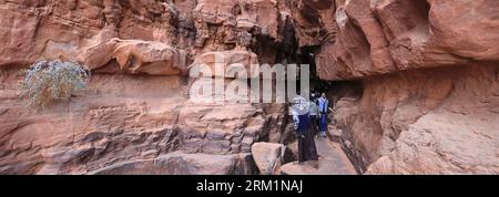 People in the Khazali canyon, famous for the ancient inscriptions and waterholes, Wadi Rum, Jordan, Middle East Stock Photo