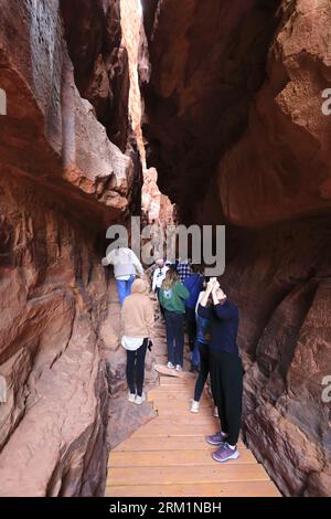 People in the Khazali canyon, famous for the ancient inscriptions and waterholes, Wadi Rum, Jordan, Middle East Stock Photo