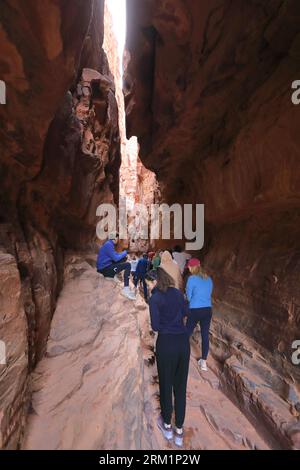 People in the Khazali canyon, famous for the ancient inscriptions and waterholes, Wadi Rum, Jordan, Middle East Stock Photo