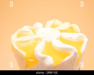 Lemon ice cream waffle cups. Ice cream on an orange background. Stock Photo