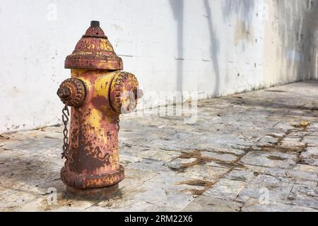 An old rusty fire hydrant on a street of Guayaquil, selective focus, Ecuador. Stock Photo