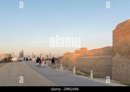 Tourists at Qal'at al-Bahrain - Bahrain Fort, Fortress in Al Qala, Bahrain Stock Photo