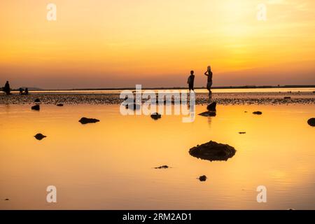 Two boys walking with filled water filled in plastic containers, Stock Photo