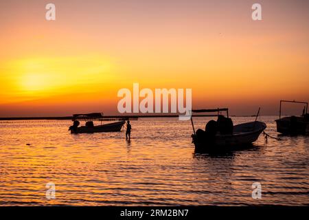 Fishing boats at sunset at Karbabad beach, Seef beach Bahrain Stock Photo