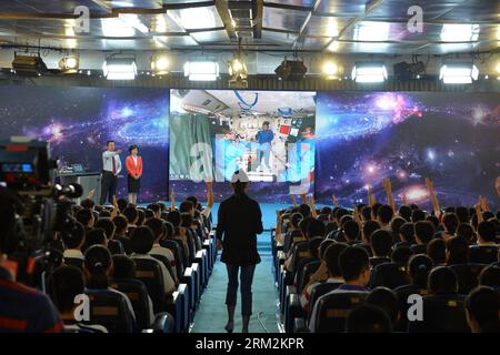 Bildnummer: 59870562  Datum: 20.06.2013  Copyright: imago/Xinhua (130620) -- BEIJING, June 20, 2013 (Xinhua) -- Students raise their hands to ask questions to the female astronaut Wang Yaping, one of the three crew members of Shenzhou-10 spacecraft, at the High School Affiliated to Renmin University of China, in Beijing, capital of China, June 20, 2013. A special lecture began Thursday morning, given by Wang Yaping aboard China s space module Tiangong-1 to students on Earth. (Xinhua/Li Xin) (zwx) (SHENZHOU-10-TIANGONG-1) CHINA-SHENZHOU-10-TIANGONG-1-SPACE LECTURE (CN) PUBLICATIONxNOTxINxCHN Ge Stock Photo