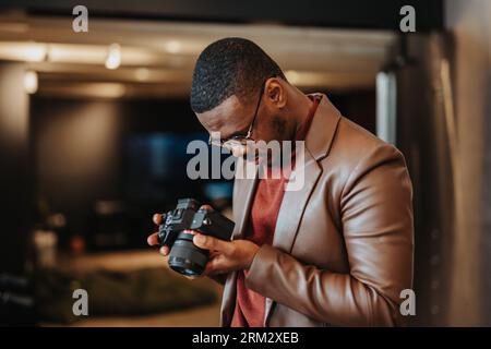 The photographer is adjusting the settings on the camera in order to capture the best shot. Stock Photo