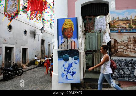 Bildnummer: 59917547  Datum: 28.06.2013  Copyright: imago/Xinhua BAHIA, June 28, 2013 - A woman walks in front of pictures and clothes on a street in the neighborhood of Pelourinho, in Salvador de Bahia, Bahia state, Brazil, on June 28, 2013. The neighborhood of Pelourinho is located in the historical center of Salvador de Bahia and part of the historical heritage of the UNESCO. Bahia will be the venue of third and fourth place match of the FIFA s Confederations Cup Brazil 2013. (Xinhua/Nicolas Celaya) (itm) (SP)BRAZIL-BAHIA-CONFEDERATIONS-DAILY LIFE PUBLICATIONxNOTxINxCHN xas x0x 2013 quer Stock Photo