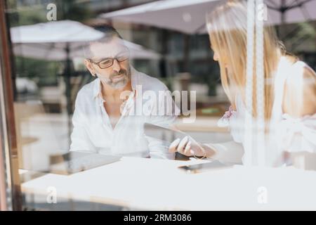 Businesspeople discussing innovative ideas, analyzing statistics, and problem-solving in a multicultural office setting. Stock Photo