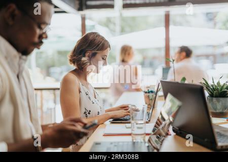 A multicultural group of businesspeople working together, analyzing statistics, discussing projects, and sharing innovative ideas for successful busin Stock Photo