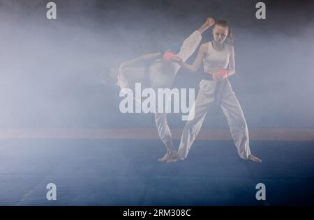 Good looking karate friends fight while doing karate pose at the karate ...