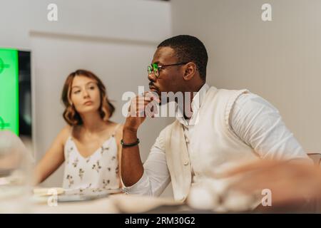 A diverse business team analyzing analytic, discussing profit growth and project development, in a creative and collaborative office workspace. Stock Photo